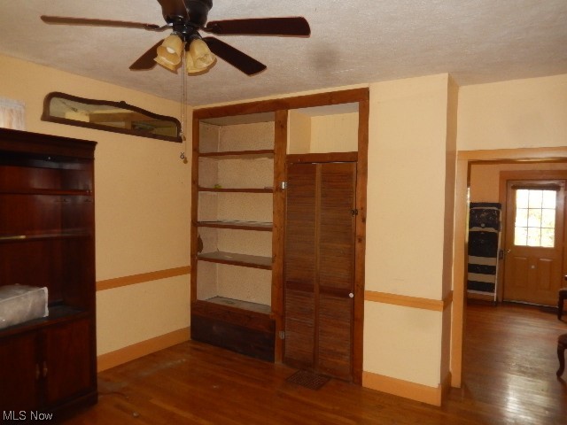 1302 Duncan Street Southwest Massillon, OH 44647 - Photo 9 of 22 Unfurnished bedroom with a closet, a textured ceiling, dark hardwood floors, and ceiling fan