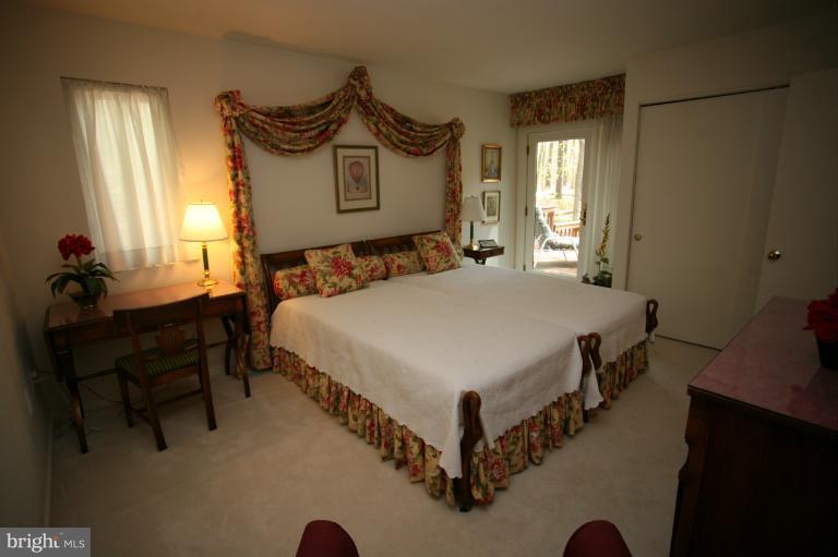 10927 Lawyers Road Reston, VA 20191 - Photo 20 of 30 a bedroom with a bed a table and chair