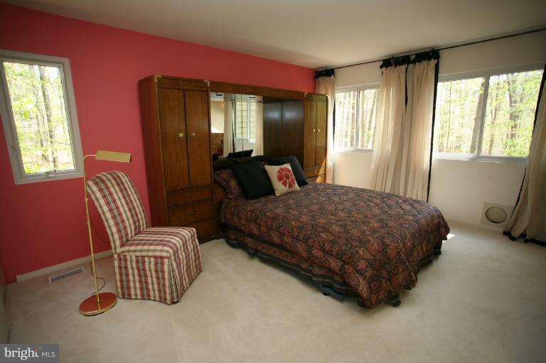 10927 Lawyers Road Reston, VA 20191 - Photo 3 of 30 a bedroom with a bed and wooden floor