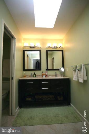 10927 Lawyers Road Reston, VA 20191 - Photo 25 of 30 a bathroom with a sink and a mirror