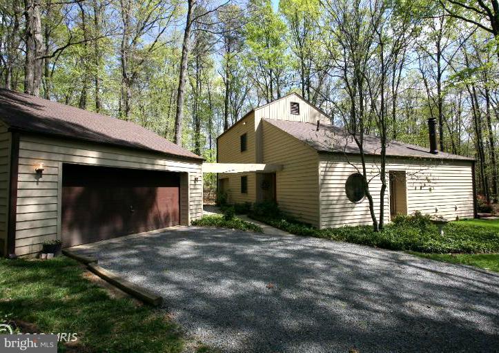 10927 Lawyers Road Reston, VA 20191 - Photo 29 of 30 a view of a house with a yard and garage