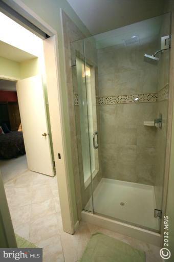 10927 Lawyers Road Reston, VA 20191 - Photo 4 of 30 a bathroom with a glass shower door