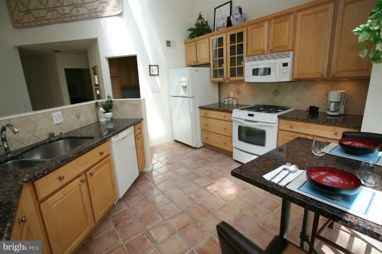 10927 Lawyers Road Reston, VA 20191 - Photo 9 of 30 a kitchen with stainless steel appliances granite countertop a stove a sink and a refrigerator