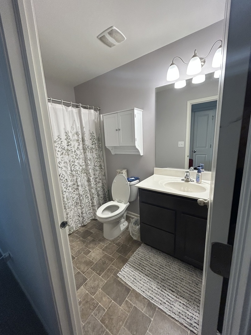 582 Spring Leaf Drive Joliet, IL 60431 - Photo 20 of 25 a bathroom with a double vanity sink toilet and a mirror