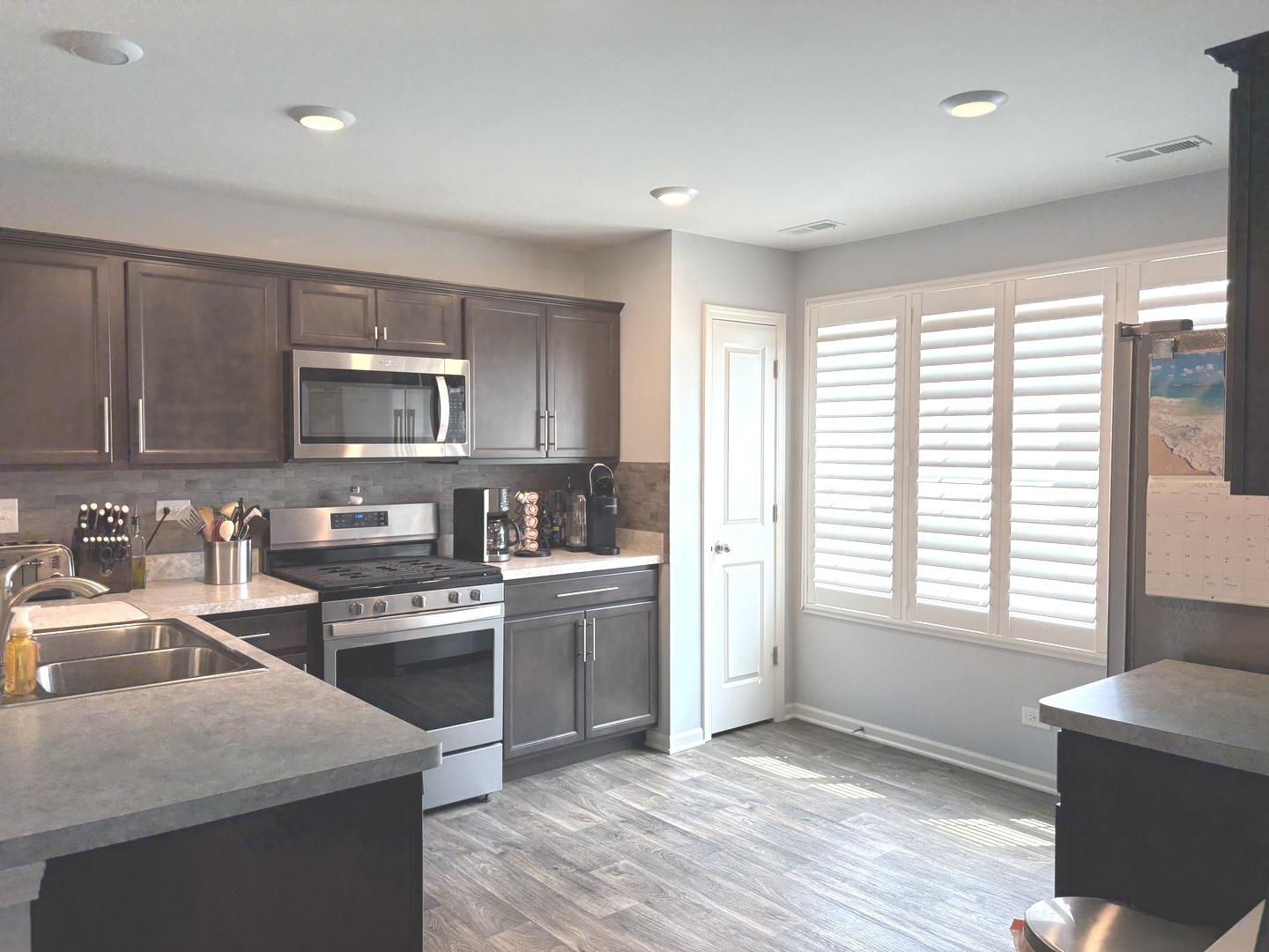 582 Spring Leaf Drive Joliet, IL 60431 - Photo 9 of 25 a kitchen with a stove a sink and a microwave