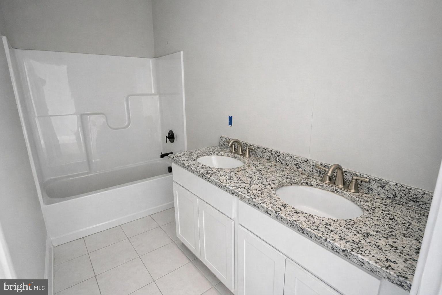 1 Jersey Road Salisbury, MD 21801 - Photo 15 of 19 a bathroom with a granite countertop sink a toilet and bathtub
