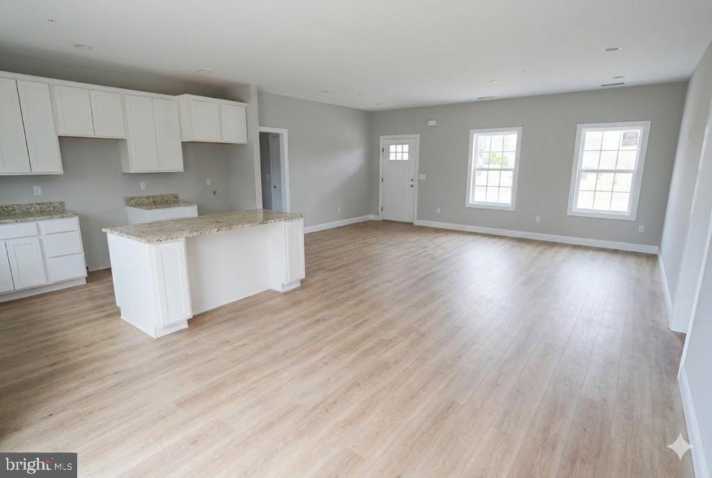 1 Jersey Road Salisbury, MD 21801 - Photo 6 of 19 a living room with stainless steel appliances granite countertop a wooden floors and white walls