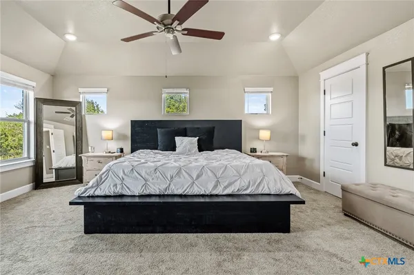 a spacious bedroom with a bed and a couch