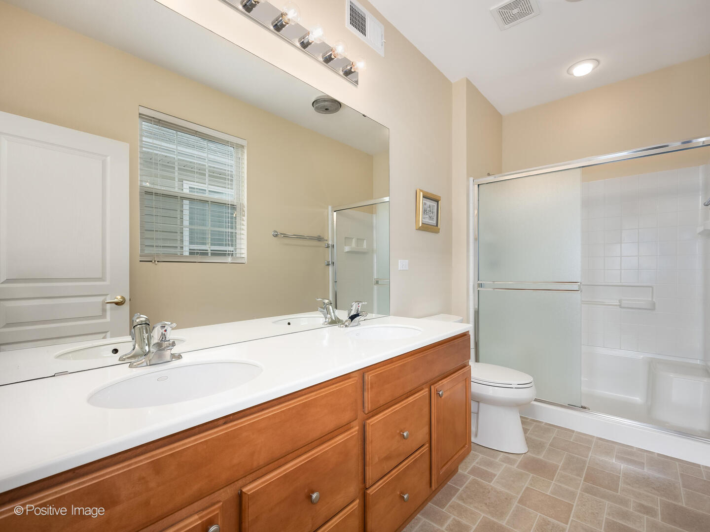 13497 Morgan Way Huntley, IL 60142 - Photo 12 of 19 a bathroom with a double vanity sink toilet mirror and shower
