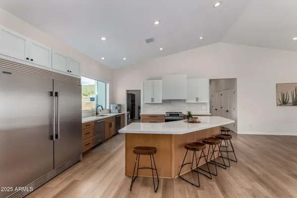 a large kitchen with lots of counter top space a sink and appliances