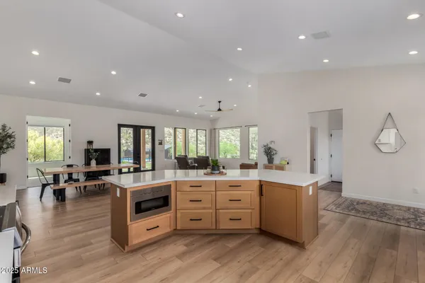 a kitchen with sink and large window