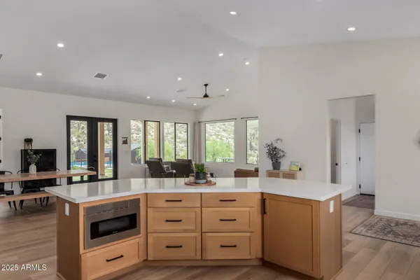 a large kitchen with stainless steel appliances kitchen island granite countertop a sink counter space and stainless steel appliances