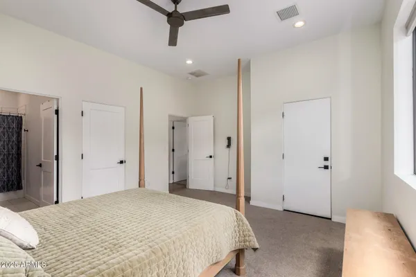 a bedroom with a bed and a ceiling fan