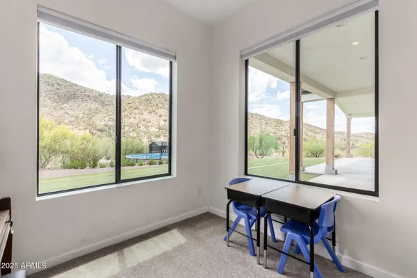 a view of a room with gym equipment and a large window