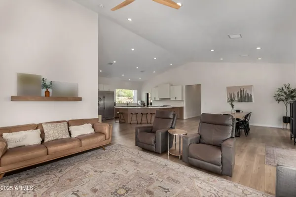 a living room with furniture and kitchen view