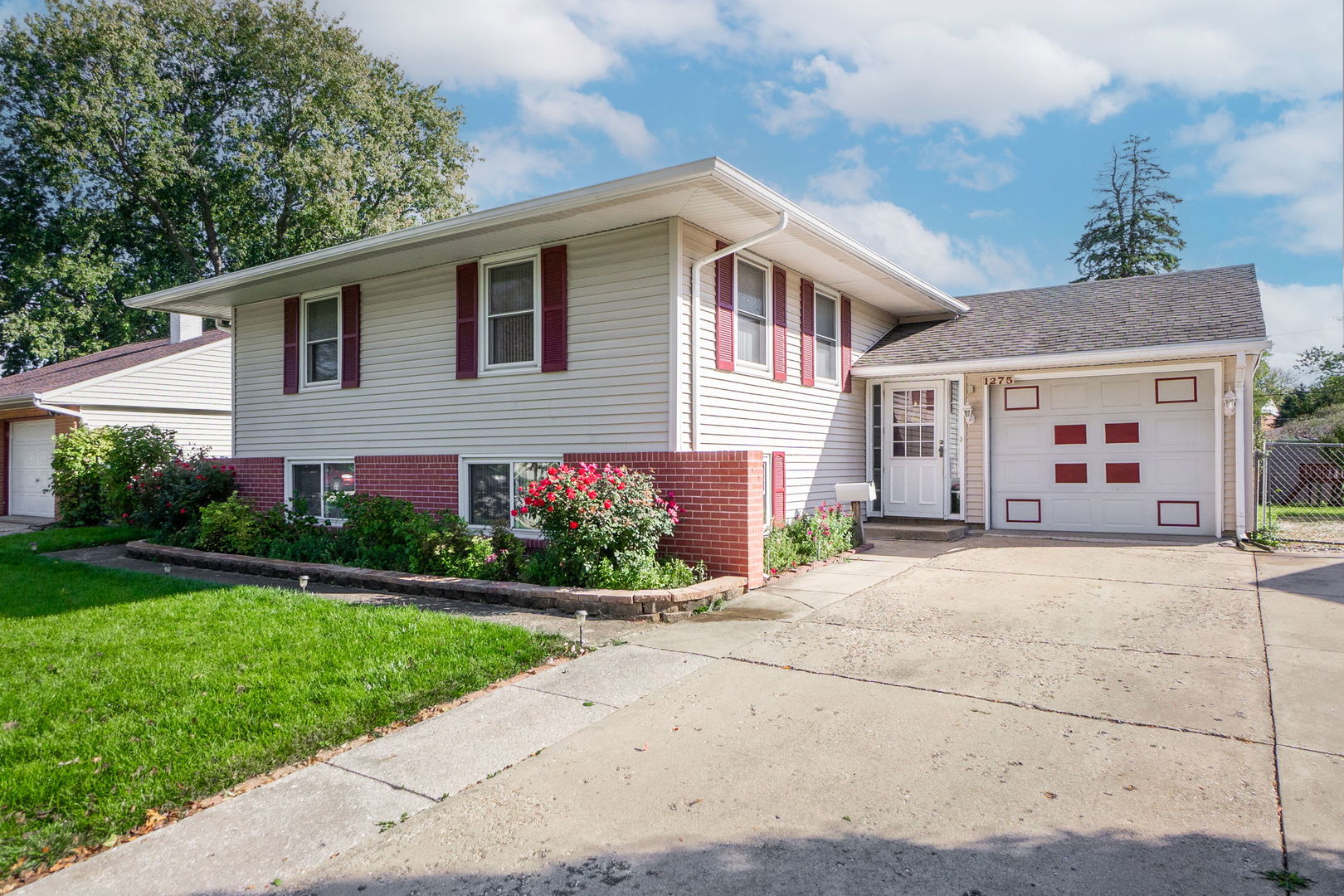 1275 Post Road Aurora, IL 60506 - Photo 2 of 30 a front view of a house with a yard and a garage