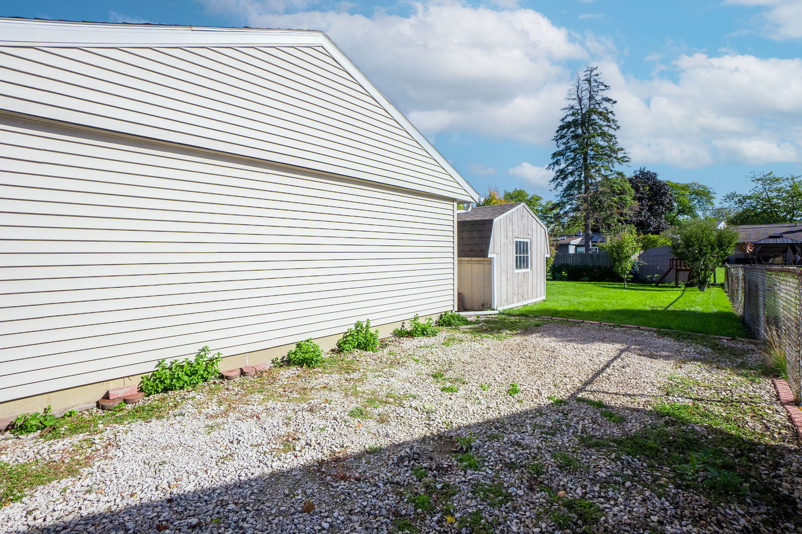 1275 Post Road Aurora, IL 60506 - Photo 22 of 30 a small white house with a yard and garage