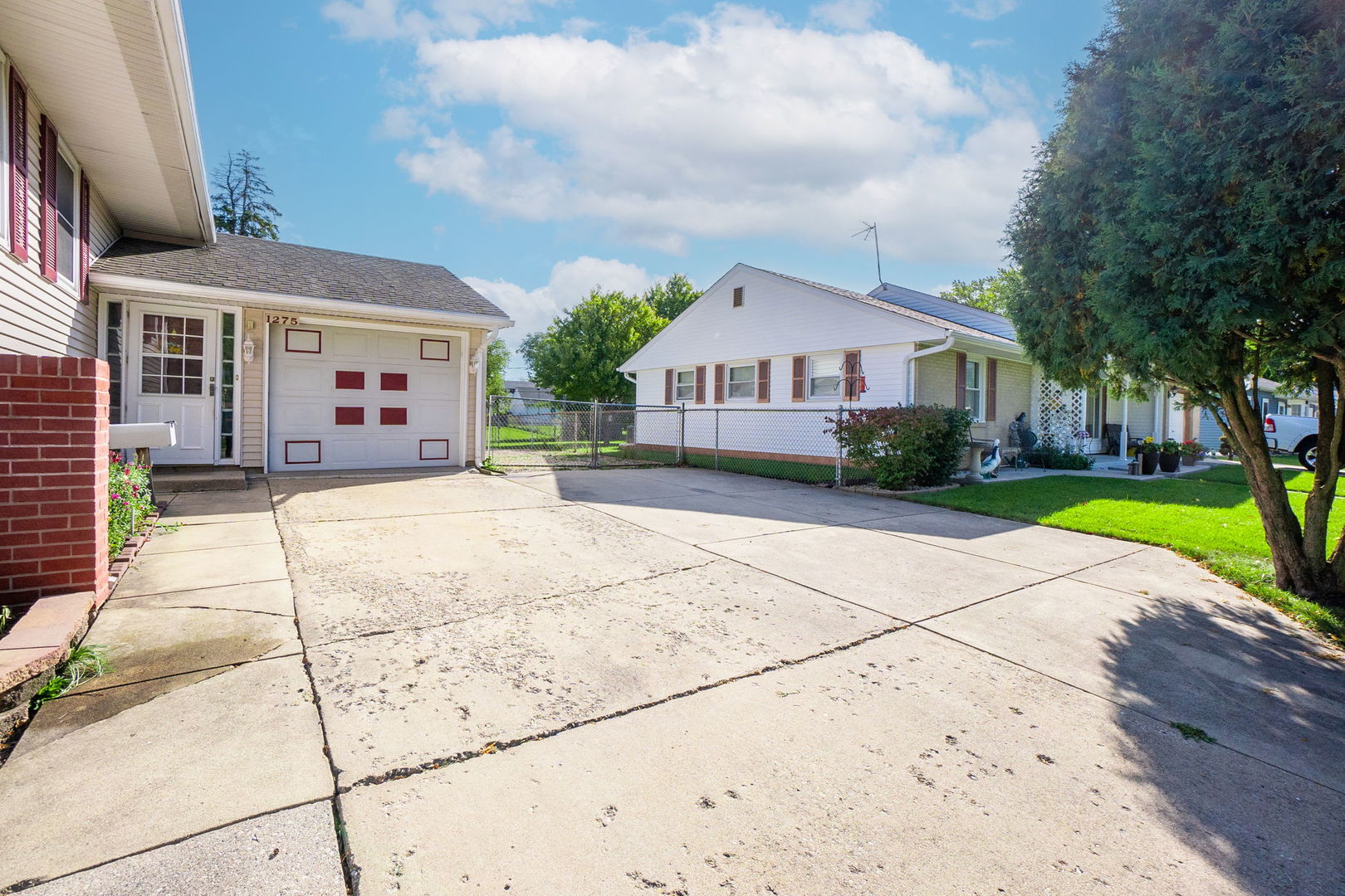1275 Post Road Aurora, IL 60506 - Photo 3 of 30 a front view of a house with a yard and potted plants