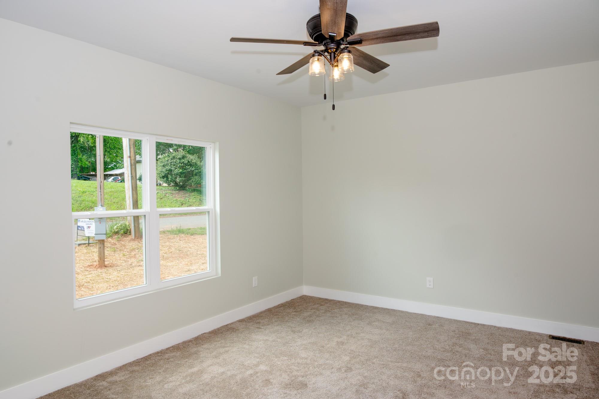 43 Robbins Circle Lexington, NC 27292 - Photo 11 of 28 an empty room with a window and a fan