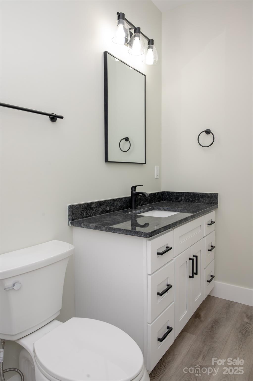 43 Robbins Circle Lexington, NC 27292 - Photo 13 of 28 a bathroom with a granite countertop toilet sink and mirror