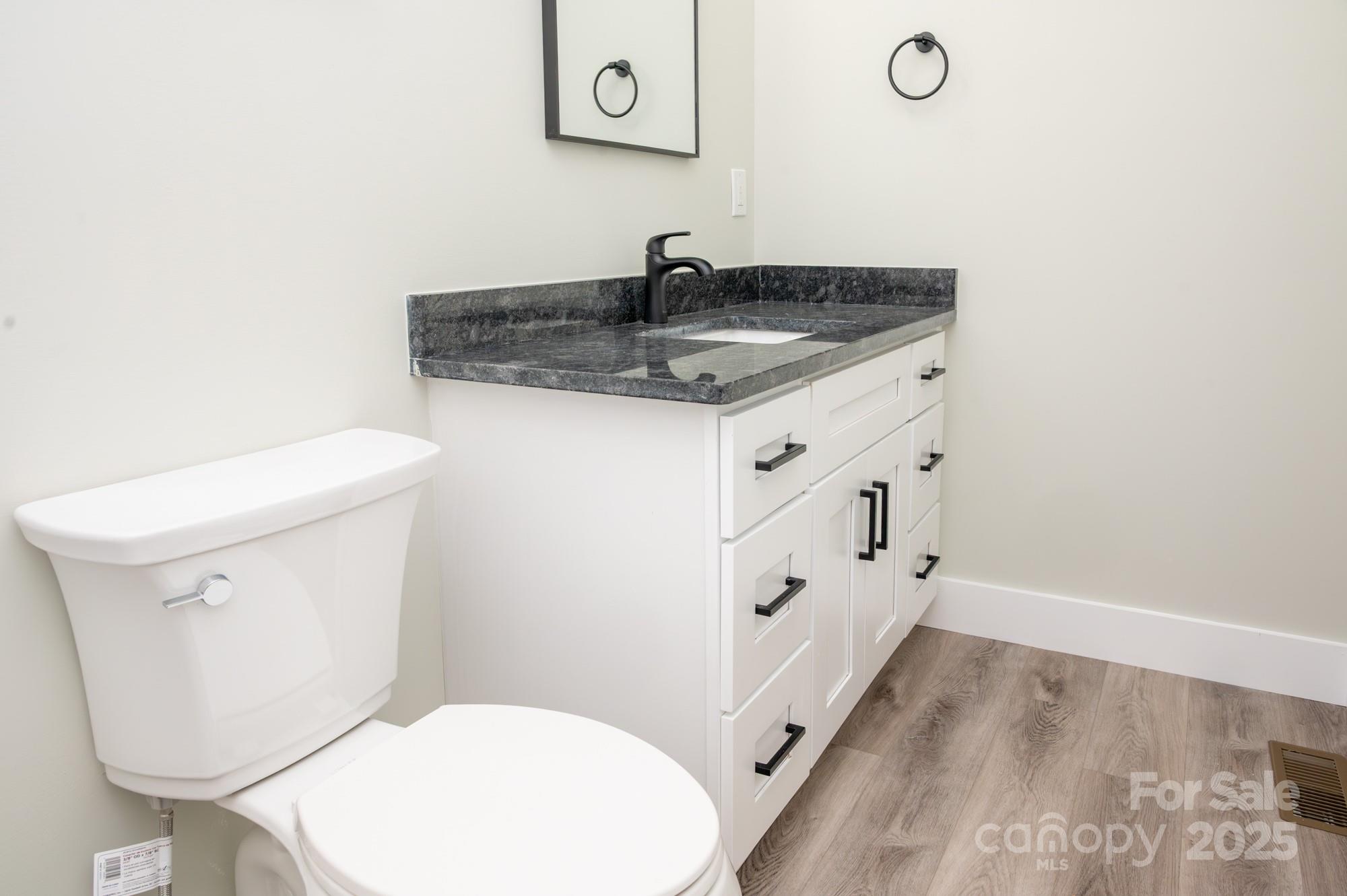 43 Robbins Circle Lexington, NC 27292 - Photo 14 of 28 a bathroom with a granite countertop toilet sink and mirror