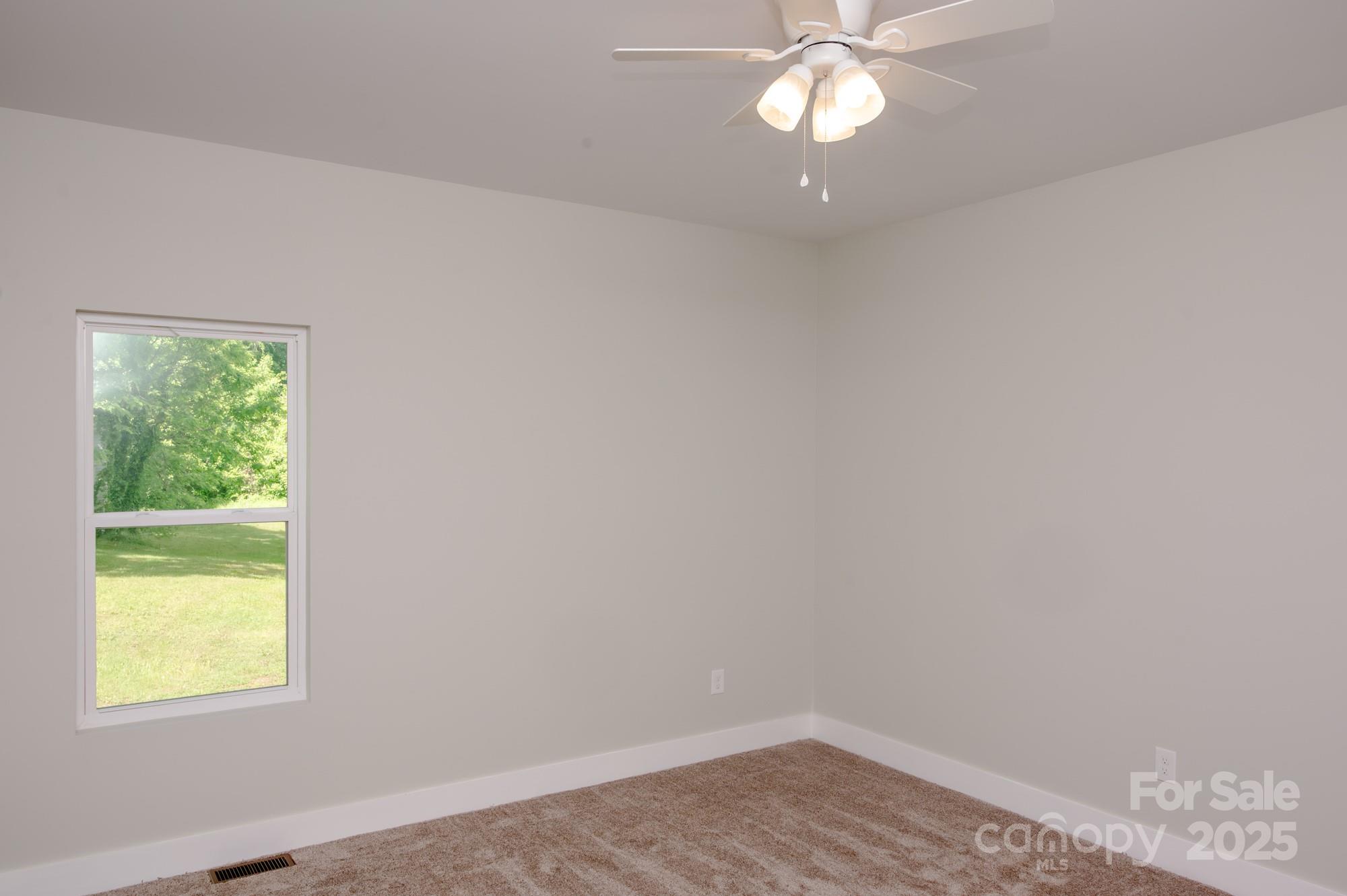 43 Robbins Circle Lexington, NC 27292 - Photo 19 of 28 an empty room with a window and a fan
