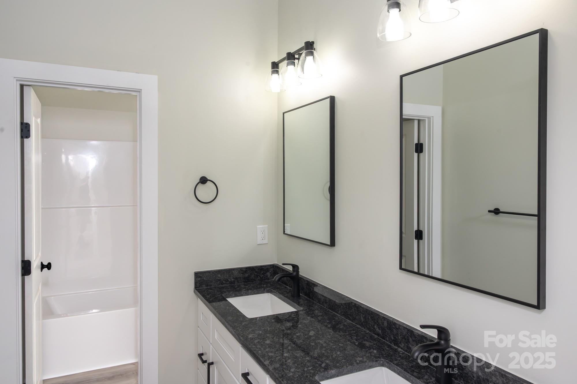 43 Robbins Circle Lexington, NC 27292 - Photo 20 of 28 a bathroom with a granite countertop sink and a mirror