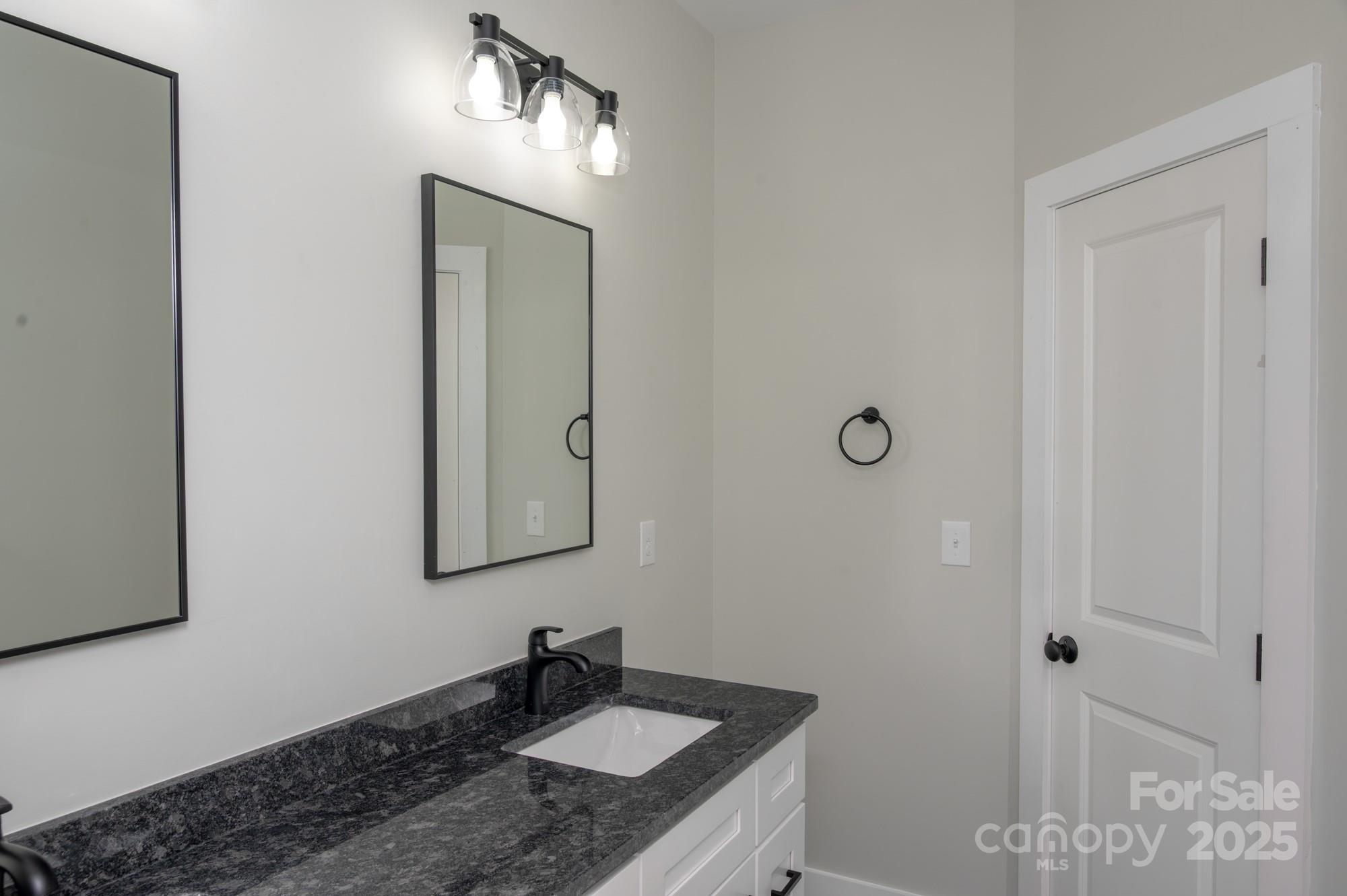 43 Robbins Circle Lexington, NC 27292 - Photo 23 of 28 a bathroom with a sink and a mirror
