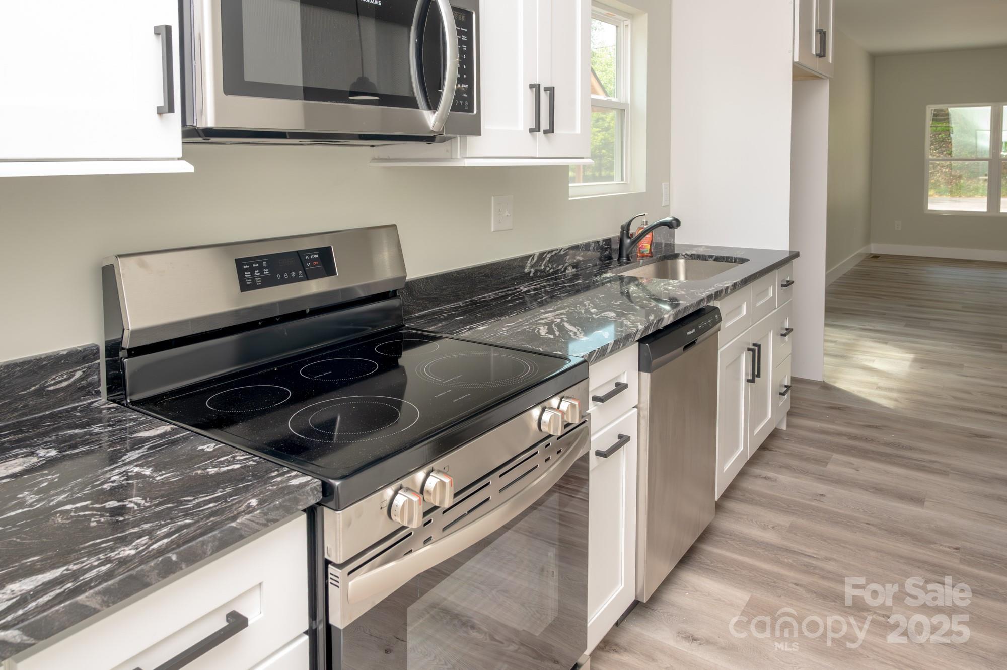 43 Robbins Circle Lexington, NC 27292 - Photo 6 of 28 a kitchen with stainless steel appliances granite countertop a sink and a stove