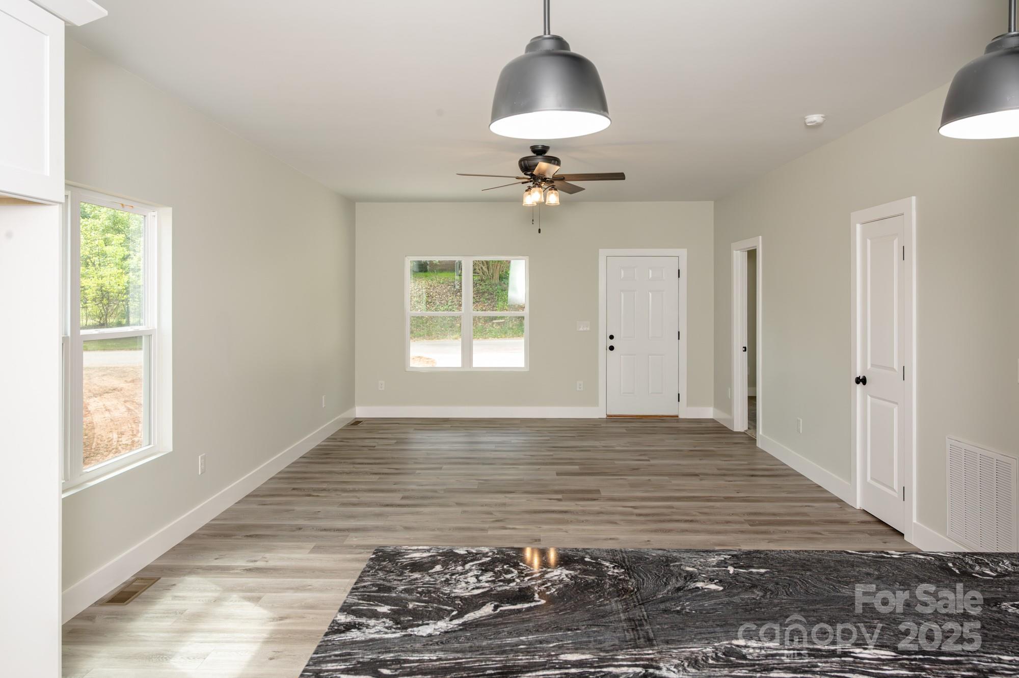 43 Robbins Circle Lexington, NC 27292 - Photo 9 of 28 a view of an empty room with a window and wooden floor