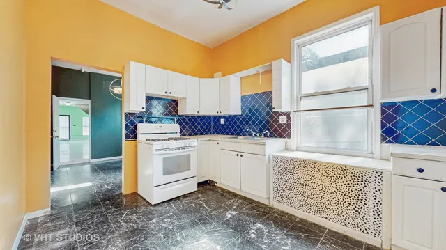 a kitchen with a stove a sink and a refrigerator