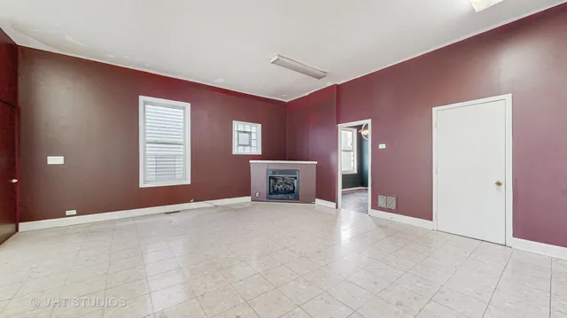 a view of an empty room with a fireplace