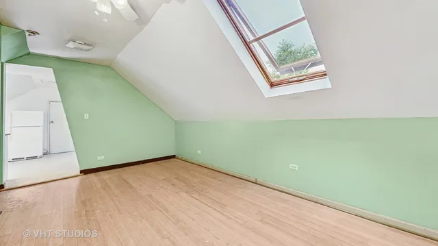 a view of a room with wooden floor and a window