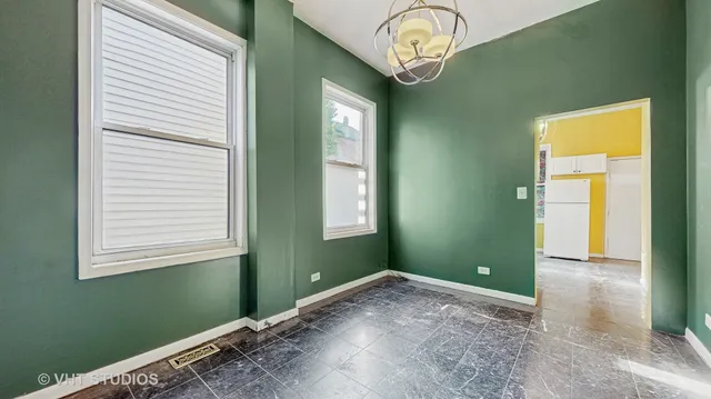 a view of a room that has a large window and a chandelier