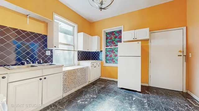 a kitchen with a refrigerator a stove top oven and a stove top oven