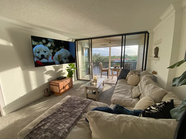 a living room with furniture and a floor to ceiling window