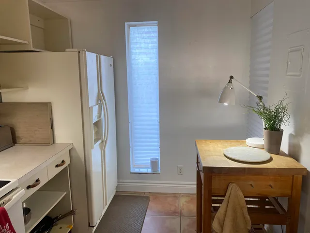 a kitchen with cabinets and white appliances
