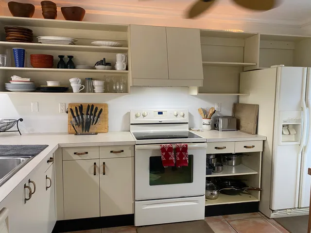 a kitchen with a sink a counter space and cabinets