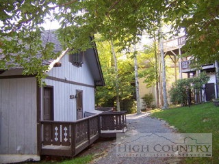 a view of backyard with deck and a garden