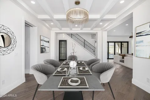 a large kitchen with stainless steel appliances granite countertop a stove and a wooden floors