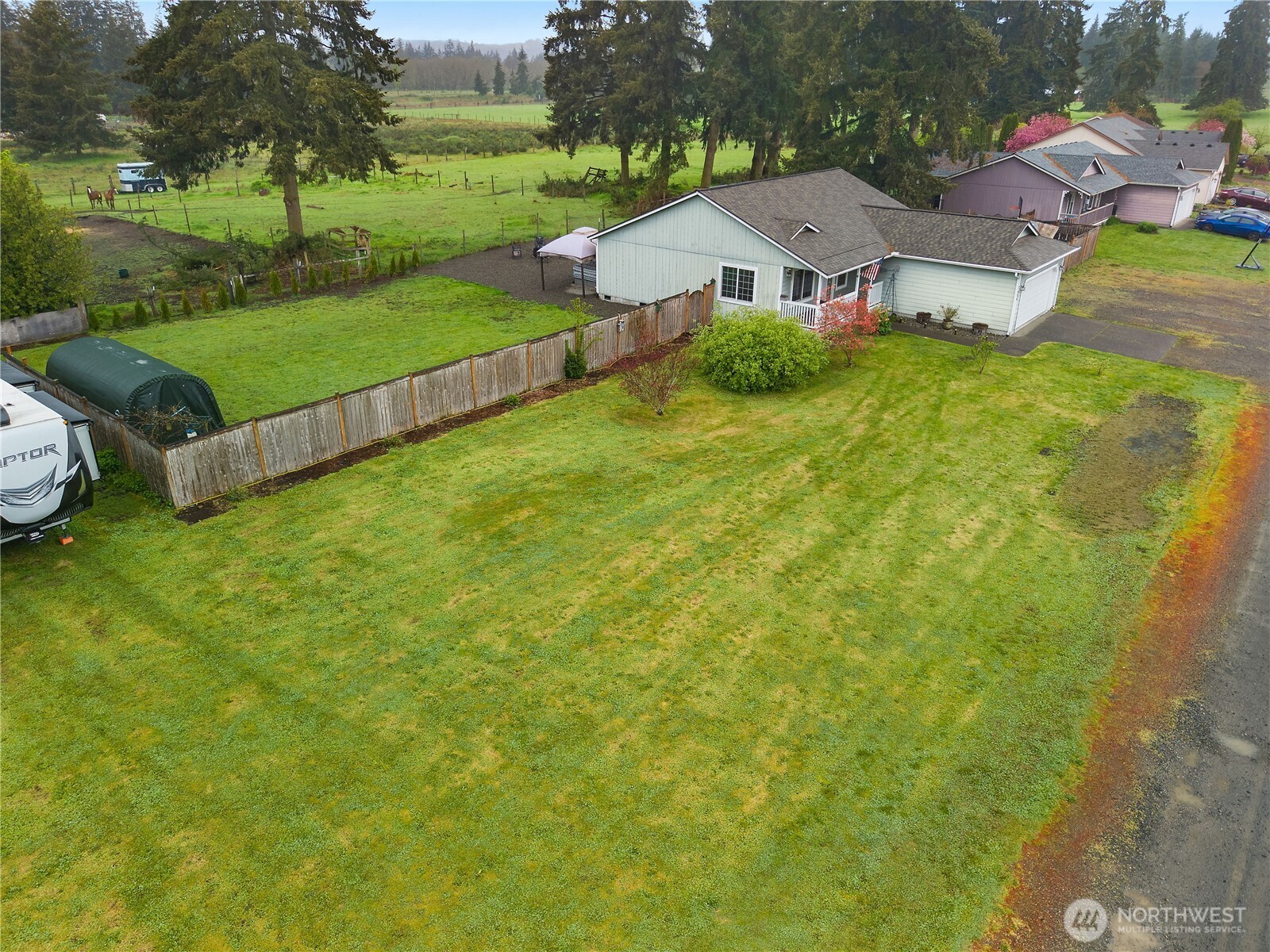 7606 187th Avenue Southwest Rochester, WA 98579 - Photo 26 of 28 an aerial view of residential houses with outdoor space and trees