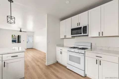 a view of an empty room and wooden floor