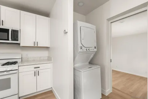 a view of a room with wooden floor