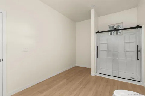 a view of a room with wooden floor