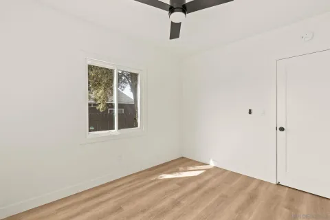 a view of a room with wooden floor and white walls