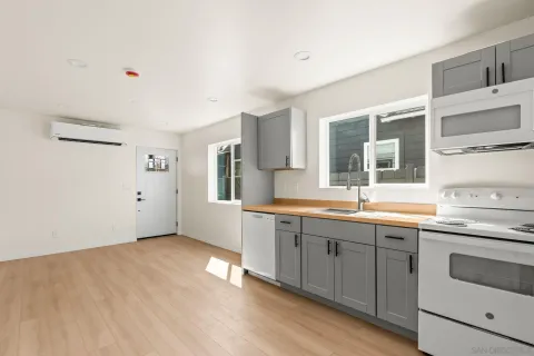a view of empty room with wooden floor and windows