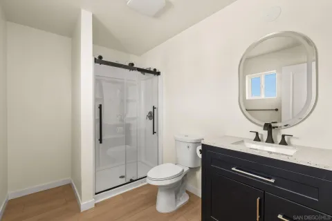 a kitchen with a white cabinets and wooden floor