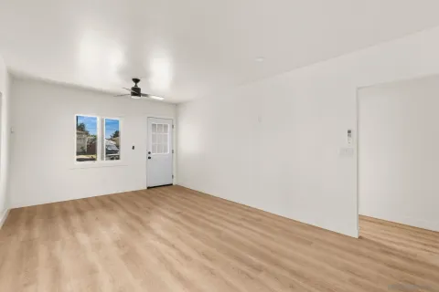 a kitchen with cabinets stainless steel appliances and wooden floor