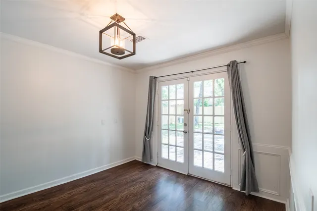 a view of a big room with windows and chandelier fan