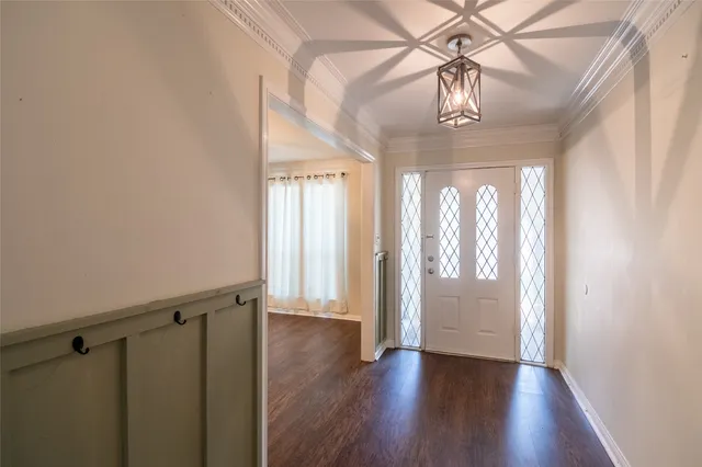 a view of an entryway with wooden floor and door